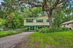 A two-story house with a green exterior and a covered porch. - Waterfront Inglis Getaway w/ Dock: 5 Mi to Gulf (Inglis)