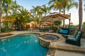 A swimming pool with a hot tub, surrounded by palm trees and outdoor furniture. - Oceanside Tropical Resort with HEATED POOL & SPA! (Oceanside)
