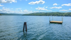 A calm lake with a wooden dock extending into the water.
