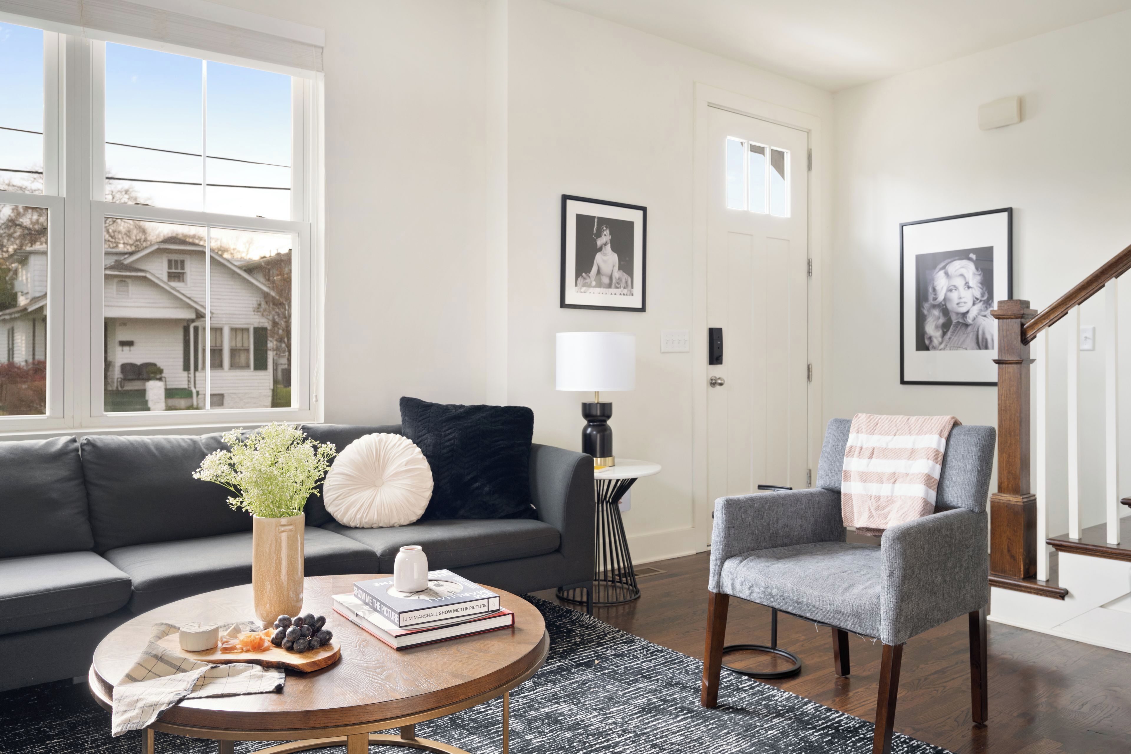 Un salon comprenant un canapé, un fauteuil, une table basse et une lampe.