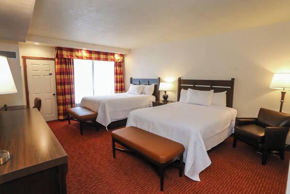 A hotel room with two beds, a bench, a desk, and a chair. - Slopeside Hotel, A Vail Resorts Property (Champion)