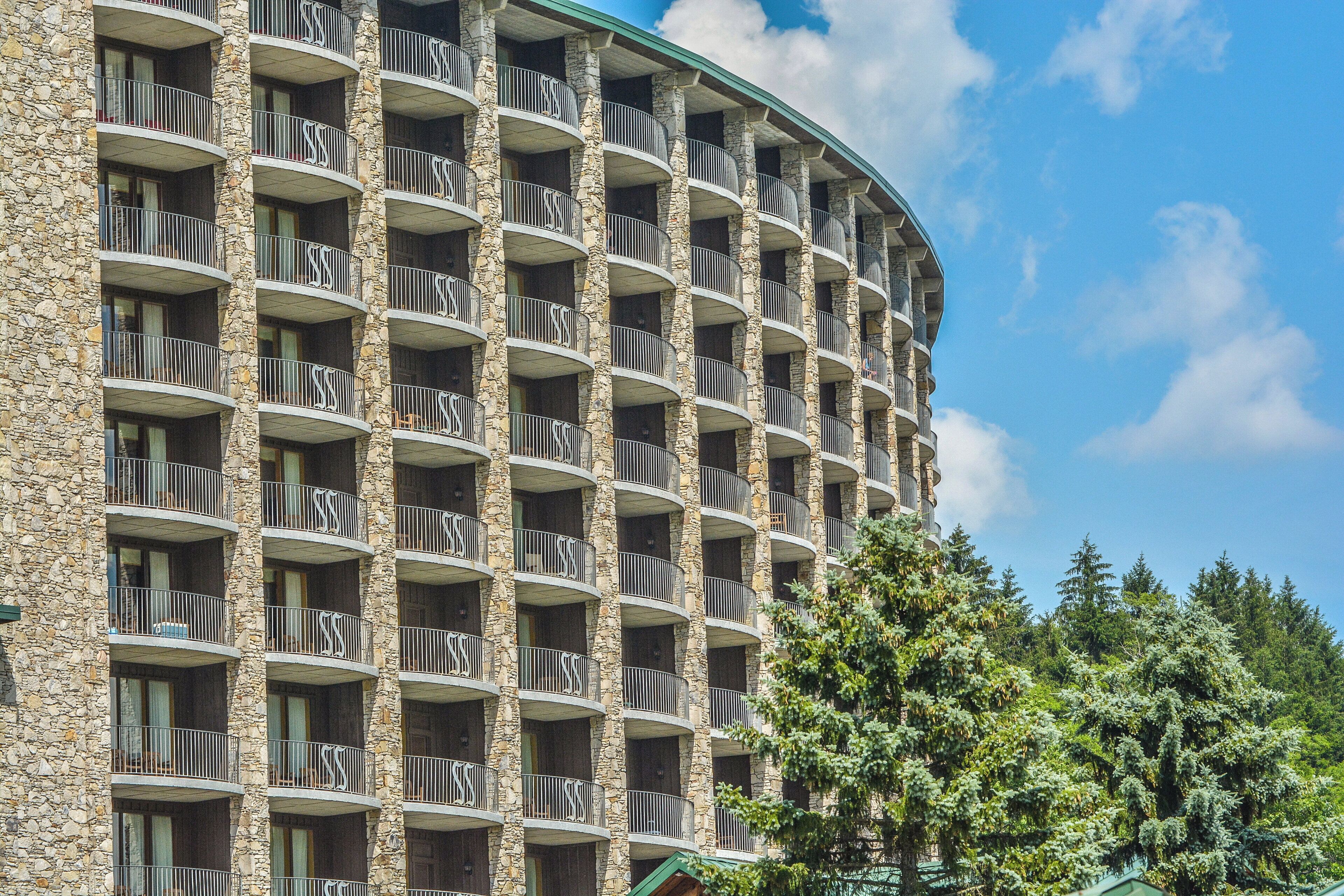 A multi-story hotel with stone facade and balconies.