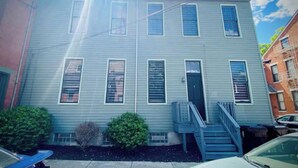 A two-story building with a central door and a staircase leading to the second floor. - Newly Renovated 3 Bed, 2 Bath Apartm! 24/7 Service (Covington)