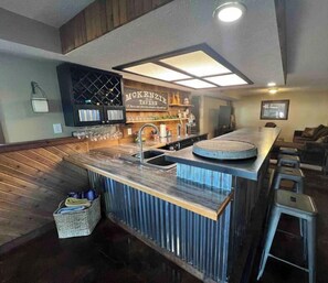 Enjoy cooking and socializing in this kitchen with a wine rack and bar counter.