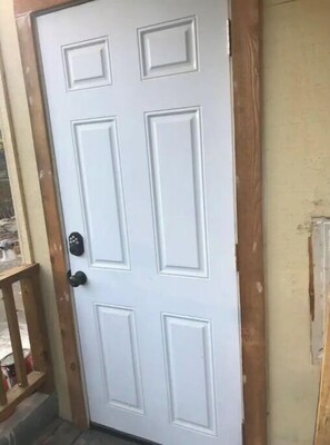 The door features a traditional design with rectangular panels and a central handle.