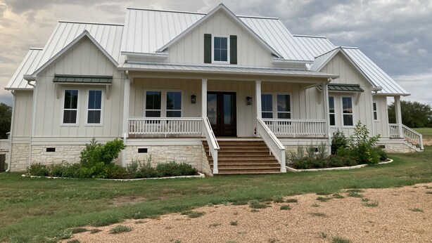 A two-story house with a front porch, a staircase leading to the entrance, and a well-maintained lawn. - Spacious 4 Bedroom House - 3/4 Mile to Round Top Center! (Round Top)