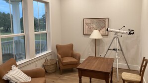 A room with a large window, a telescope, a map on the wall, and two chairs. - Spacious 4 Bedroom House - 3/4 Mile to Round Top Center! (Round Top)