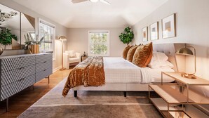 A bedroom with a bed, bedside tables, a desk, a mirror, and a ceiling fan. - BEST LOCATION DOWNTOWN, DESIGNER FURNISHINGS (Salt Lake City)