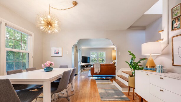 A modern kitchen with a dining area, wooden flooring, and a view to the living room. - BEST LOCATION DOWNTOWN, DESIGNER FURNISHINGS (Salt Lake City)