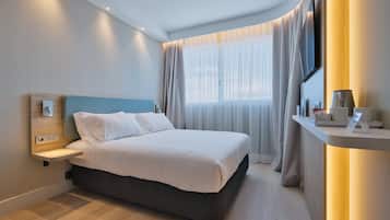Premium bedding, desk, laptop workspace, blackout curtains