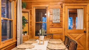A wooden dining table with placemats, chairs, and a potted plant. - NEW listing! INDOOR POOL, panoramic views, & game room - 15 min to Pigeon Forge (Sevierville)