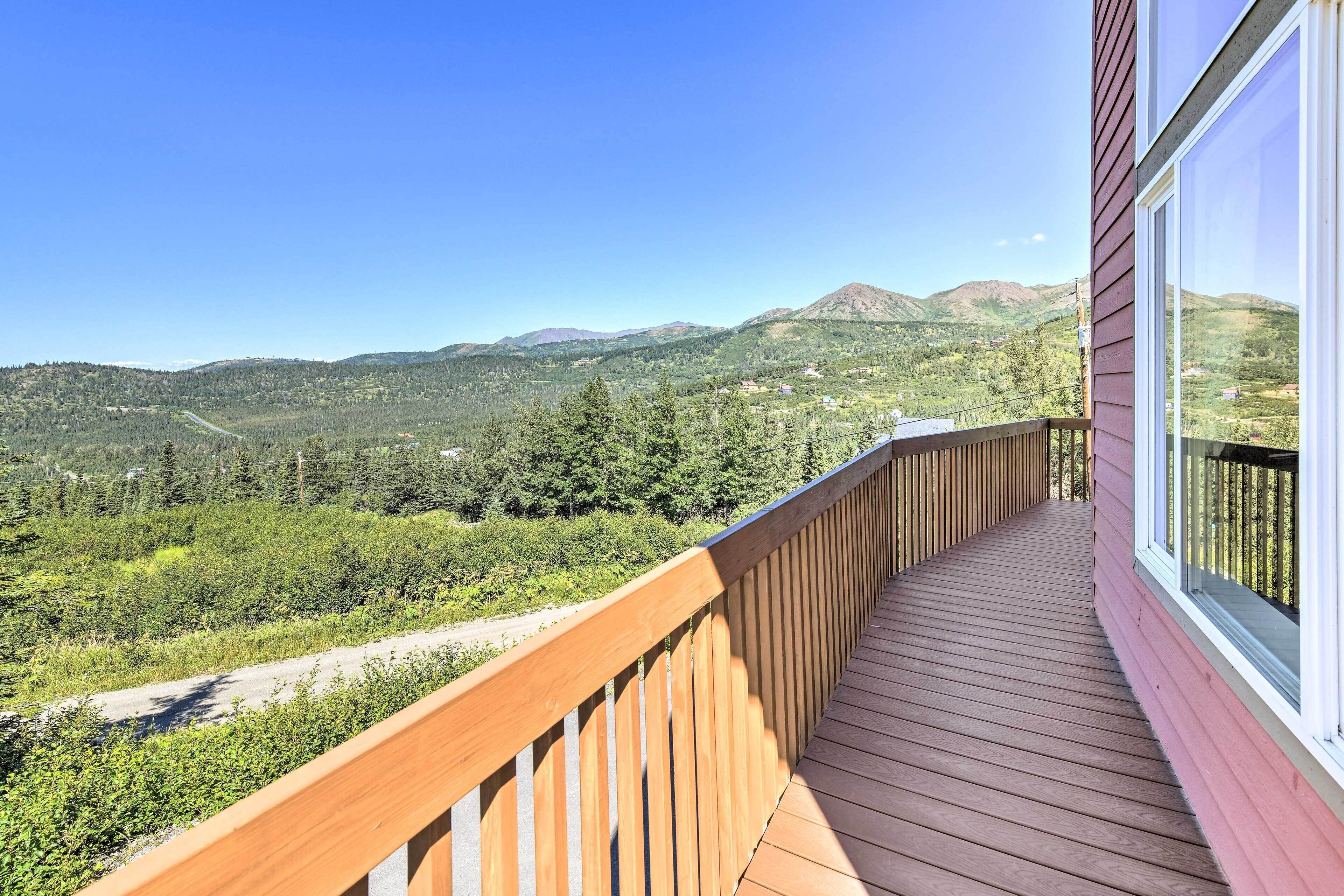 A wooden deck with a view of a mountainous landscape.