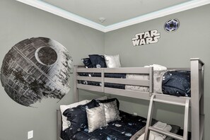 A Star Wars-themed room with bunk beds, a wall decal of a Death Star, and a Star Wars logo. - New Decor With Mickey, Nemo, Tinkerbell & Star Wars Rooms! Private Pool and Game Room (Kissimmee)