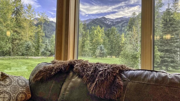 A room with a large window offering a view of a mountainous landscape. - Fernie ON THE MOUNTAIN luxury 2 bedrooms 3 beds (1 king, 2 queen), 2 baths.  (Fernie)