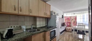 Fridge, microwave, stovetop, coffee/tea maker