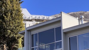 A modern building with large windows, a staircase, and a mountain view. - Iconic Queenstown Apartment (Queenstown)