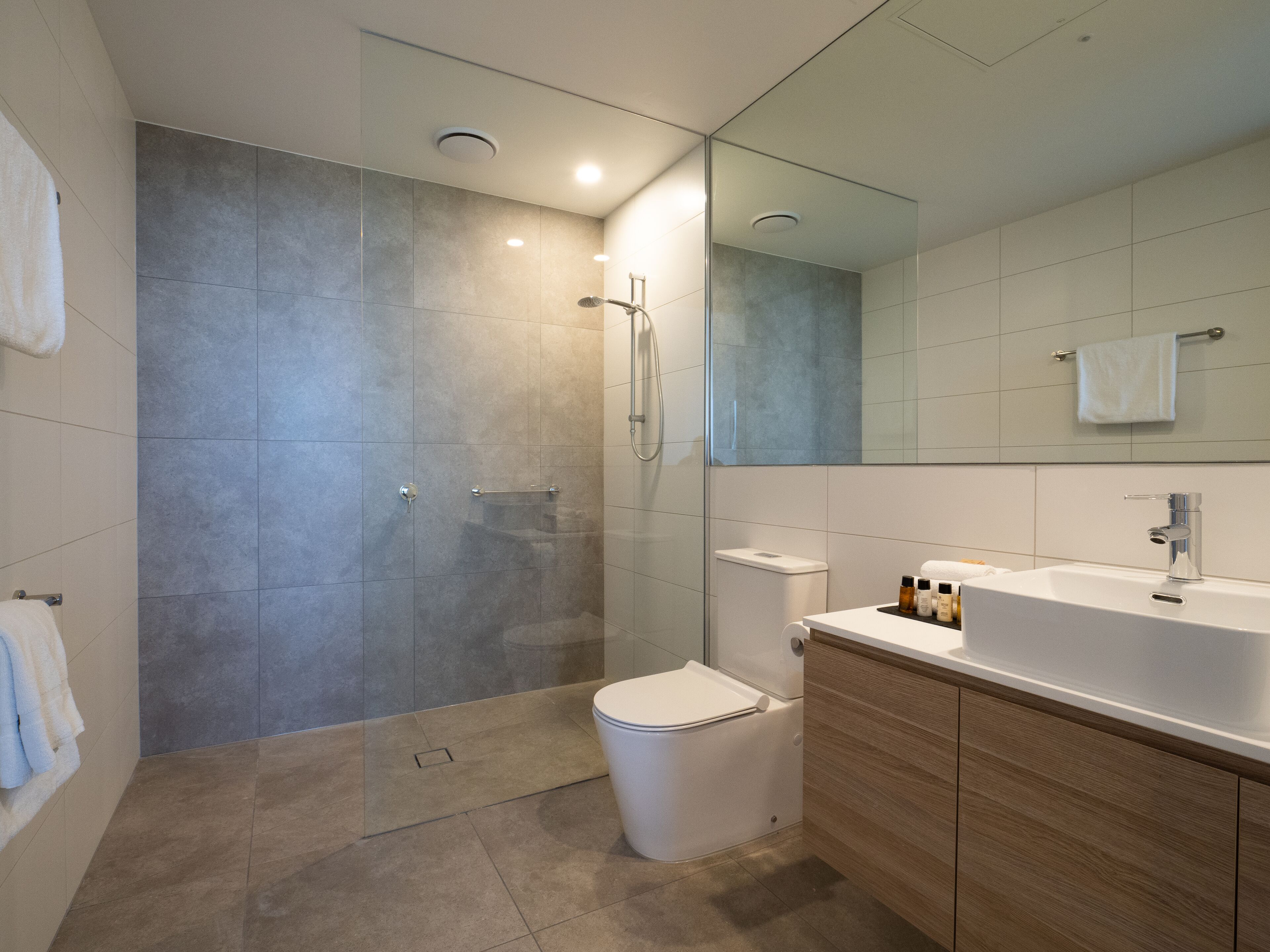 Shower, rainfall showerhead, designer toiletries, hair dryer