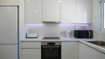 Luxury Apartment | Private kitchen | Fridge, coffee/tea maker, high chair, dining tables