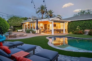 A backyard with a swimming pool, outdoor seating, and a covered patio area. - Old Town Farm-to-Table: Harvest, Pool, Spa (Scottsdale)