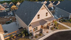 A residential area with houses featuring gabled roofs and a view of a lake. - Ingallview at Branson Cove - Indoor Pool (Hollister)