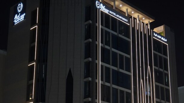 A modern hotel building with a prominent sign for "Royal Plaza Hotel Apartment." - Royal Mansoura Residence Hotel (Doha)