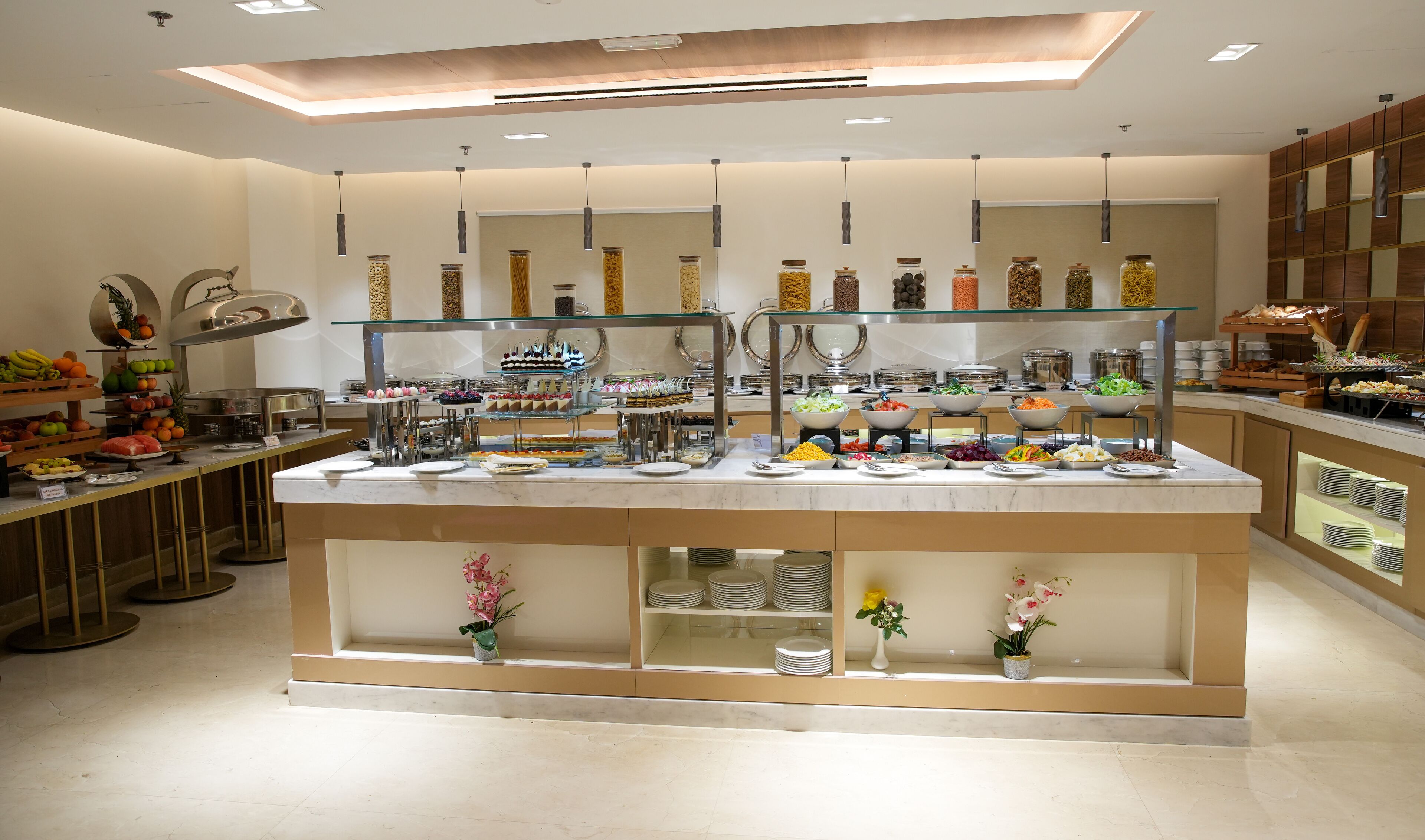 A buffet area with various food items and a glass display case.
