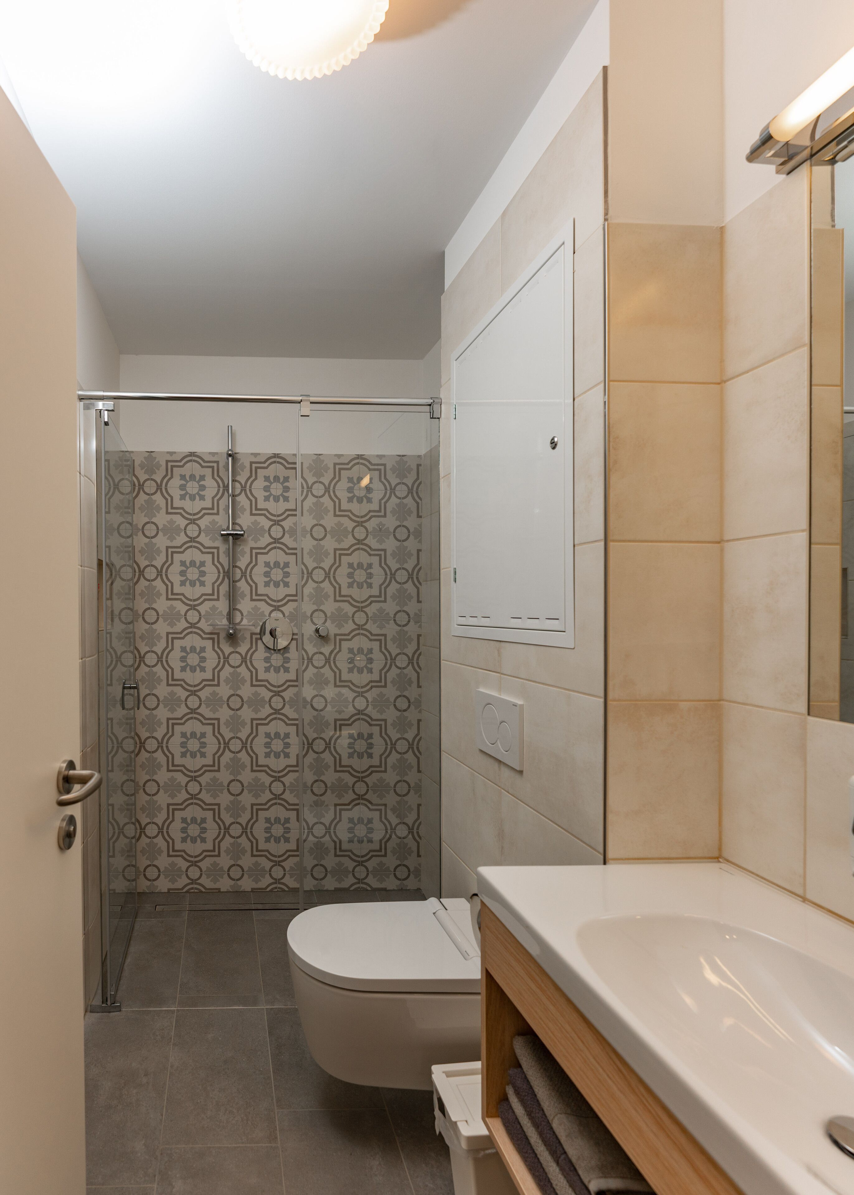 A bathroom with a shower, toilet, and sink.