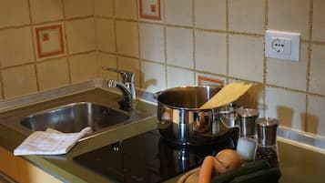 Coffee/tea maker, fridge, stovetop, cookware/dishes/utensils