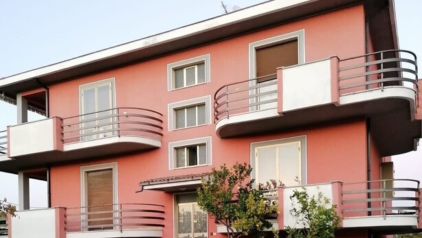 A multi-story residential building with balconies, a paved driveway, and a small lawn area. - Pet-Friendly Apartment 'Casa Rosciano' with Mountain View & Garden (rosciano)