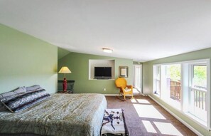 A bedroom with a bed, a chair, a TV, and a window. - Cozy secluded villa-hot tub, panoramic view, waterfalls, gorge-south skaneateles (Homer)