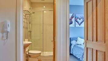 Shower, hair dryer, towels, toilet paper