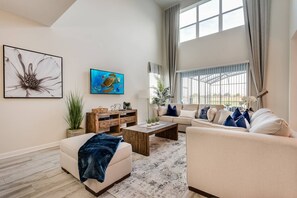Relax in this stylish living room with a sofa, coffee table, and large window offering a view.