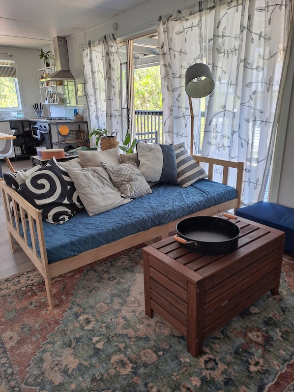 A cozy living area with a sofa, a wooden coffee table, and a patterned rug.