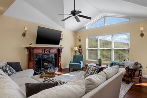 TV connectée, cheminée, table de tennis de table, livres