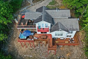 A two-story house with a deck, outdoor furniture, and a small pool. - 4Bdr Secluded! Hot Tub, Pool Table, & Spectacular Views. (Holiday Island)