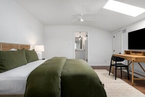 A bedroom with a bed, desk, chair, and a ceiling fan. - Fab-Fred House, Patio Oasis, Fireplace, In Town (Fredericksburg)