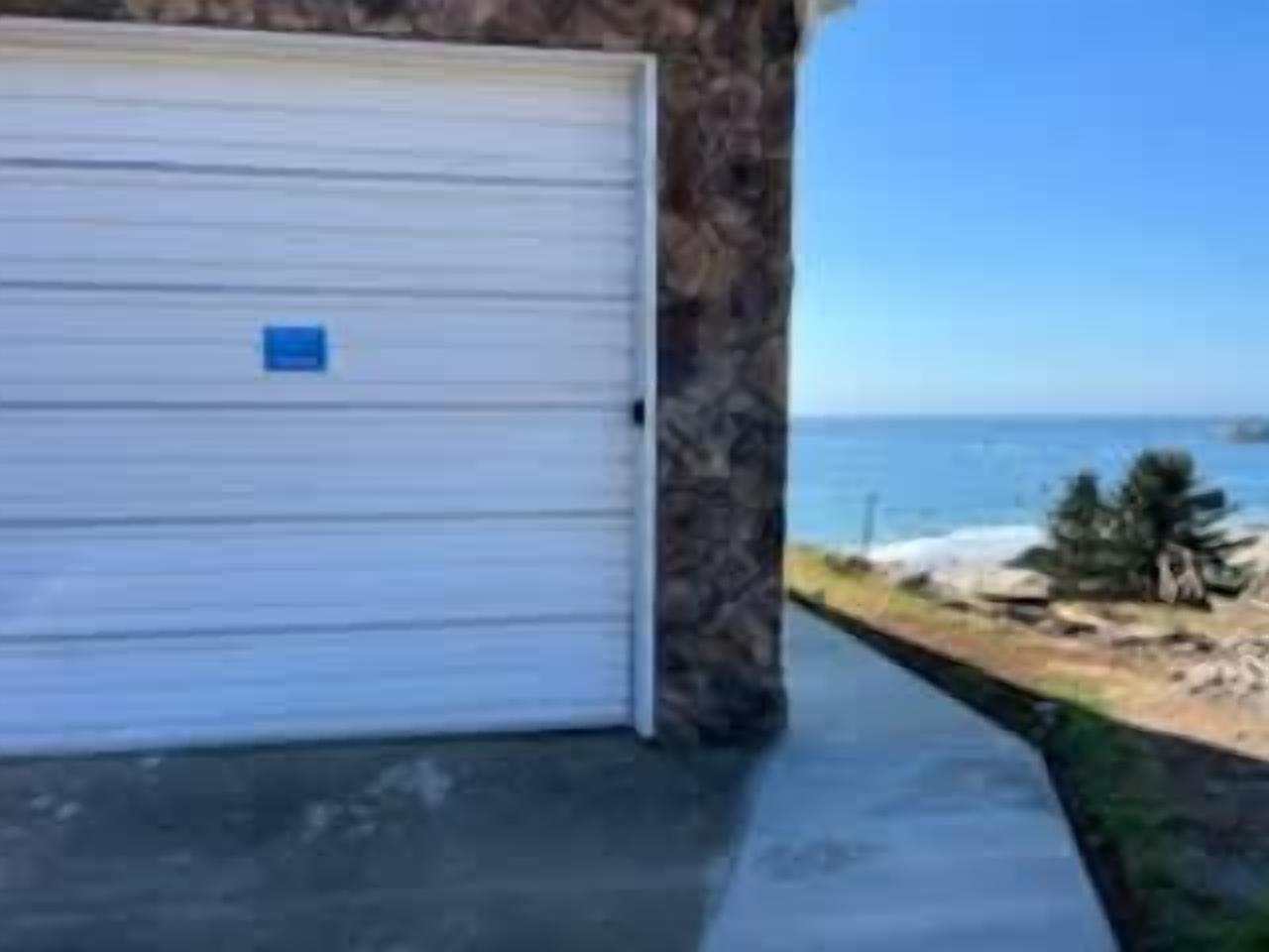 Un garage con parete in pietra e vista sull'oceano.