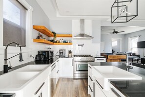 Enjoy cooking in this well-equipped kitchen with a central island, oven, and stovetop.