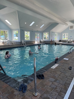 An indoor swimming pool with clear water, a tiled deck, and a metal pool ladder. - Jacana Cabana: golf cart included with no pet fee! (Myrtle Beach)