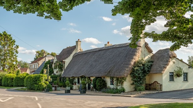 A traditional thatched-roof building with a well-maintained lawn and a clear road in front. - Beau Repaire -  Castle Howard, Coneysthorpe , Yorkshire (York)