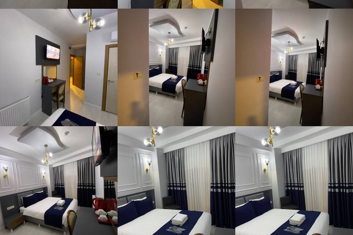 A hotel room with a large bed, a desk, a television, and a bathroom.