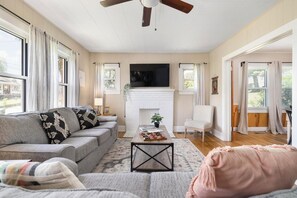 A living room with a sofa, coffee table, and a fireplace.