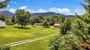 A rural landscape with a clear sky, a grassy field, a few trees, and a distant mountain range. - Private, cozy home - Handicapped Accessible no by- with great views  (Fletcher)