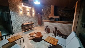Un restaurant chaleureux avec un mur en briques, des meubles en bois et un coin bar.
