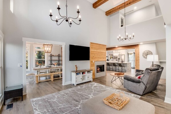 A spacious living room with a fireplace, a television, and a comfortable seating area.