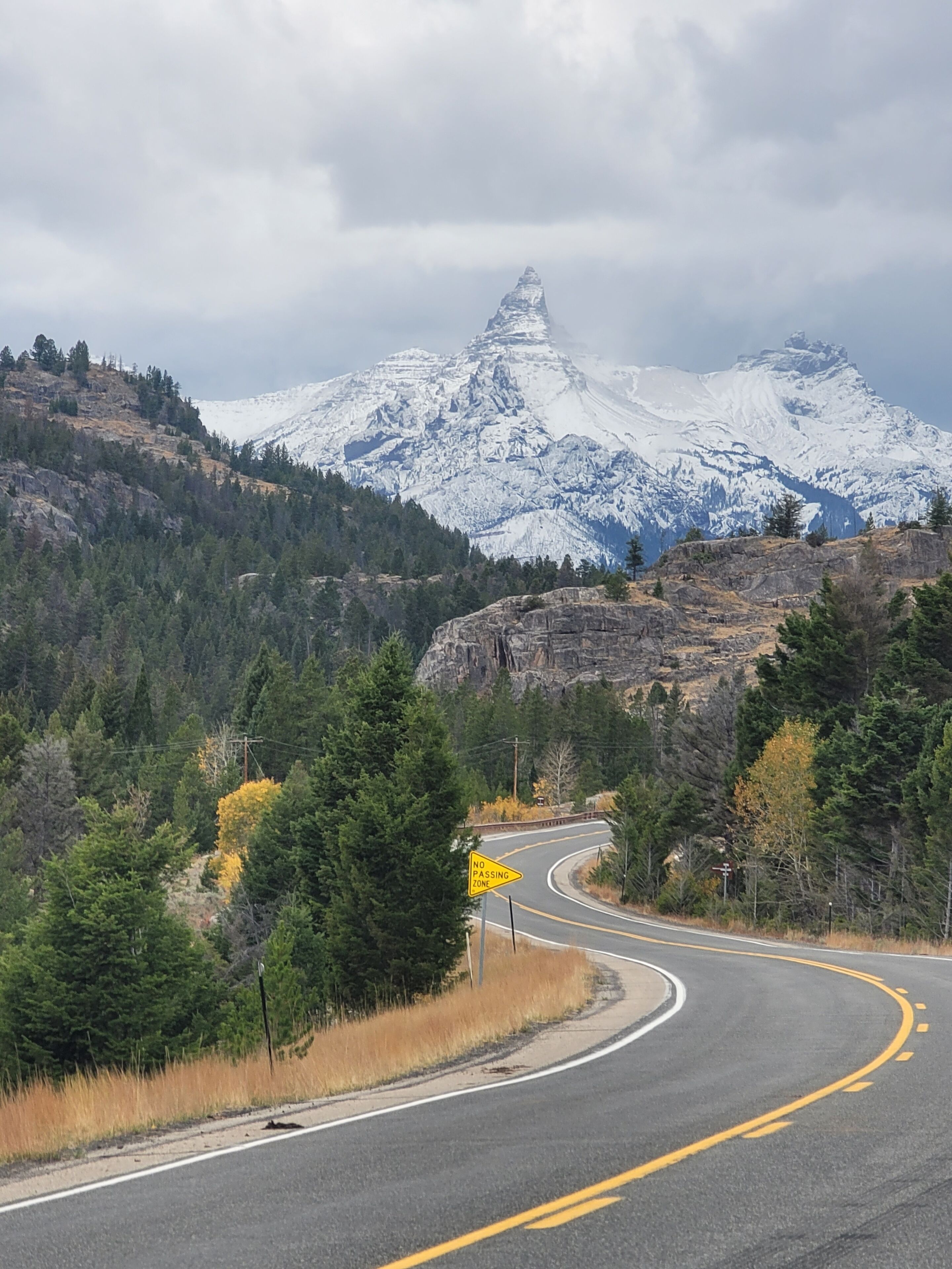 A winding road with a mountain in the background.