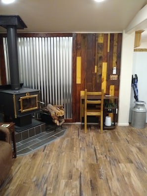Cozy living space with a stove and comfortable seating area.