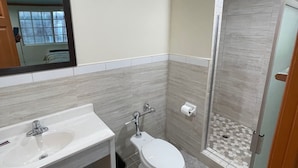 A bathroom with a sink, toilet, and shower. - Hilltop Motor Inn (Los Angeles)