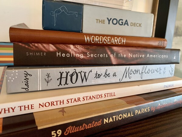 A stack of books with titles including "The Yoga Deck," "Wordsearch," and "Healing Secrets of the Native Americans."
