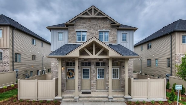 A two-story residential building with a stone facade, symmetrical design, and a central entrance with a porch. - A Modern and Executive Unit~1 Parking Spot&Great Location - Close To Everything (London)